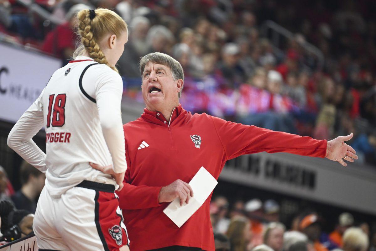 NC State women's basketball head coach Wes Moore talks to freshman center Tilda Trygger during the women's basketball game against Clemson in Reynolds Coliseum on Sunday, Dec. 29, 2024. NC State beat Clemson 83-79.