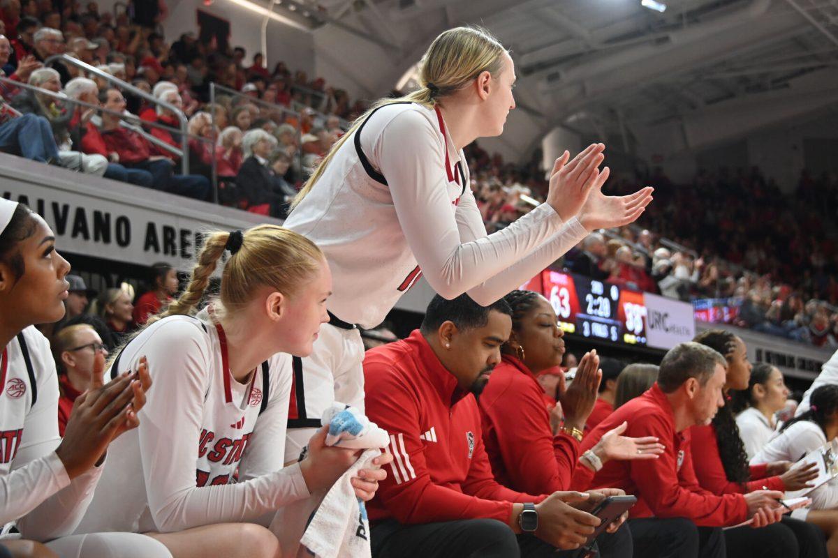 Sophomore forward Maddie Cox cheers on her teammates during the match against Virginia Tech in Reynolds Coliseum on Sunday, Jan. 26, 2025. Cox had three rebounds and one assist. The Wolfpack beat the Hokies 85-57.
