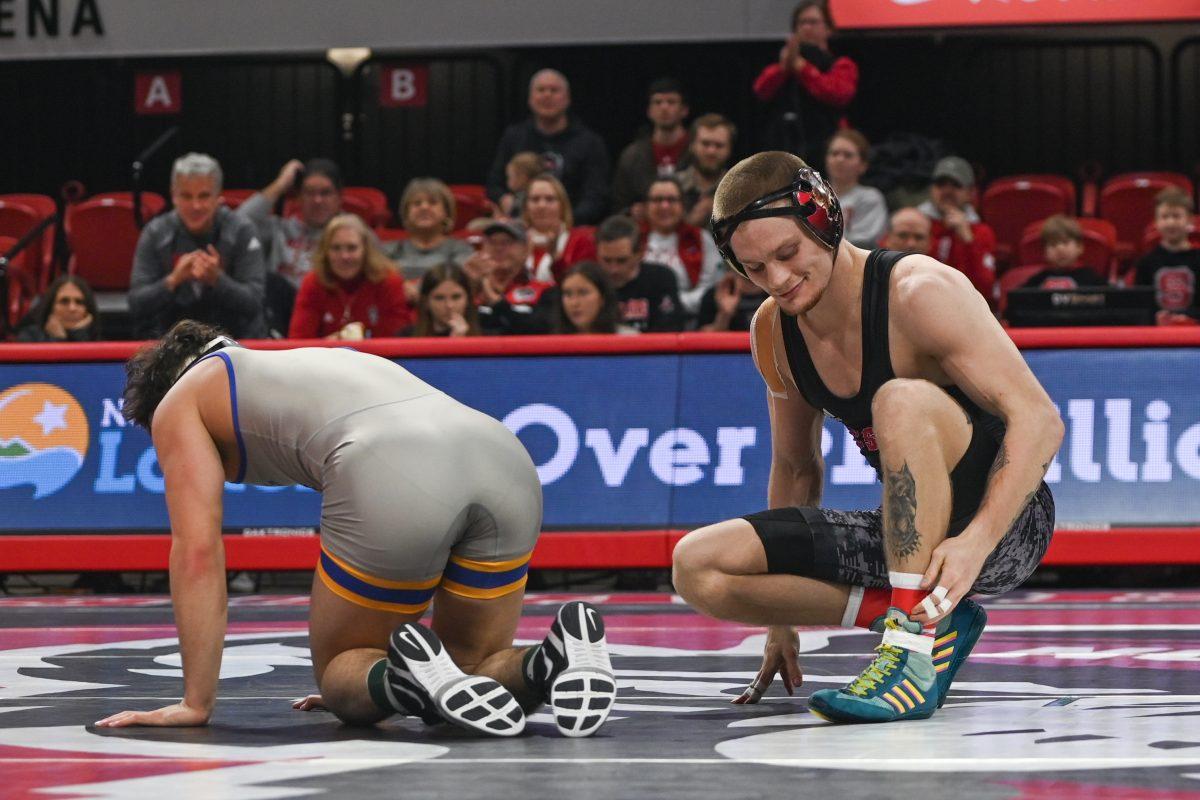 Redshirt senior Kai Orine smirks after a victory during the match against Pitt in Reynolds Coliseum on Friday, Jan. 24, 2025. Orine won the 133 bout 17-0. NC State beat Pitt 22-13.