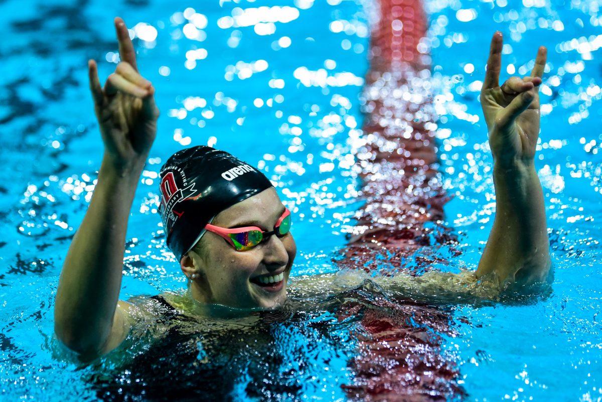 Senior Olivia Nel throws up "wolfies" after winning the women's 100 yard free during the meet against UNC-Chapel Hill in Casey Aquatics Center on Friday, Jan. 17, 2025. NC State women defeated UNC women 170.5-129.5.