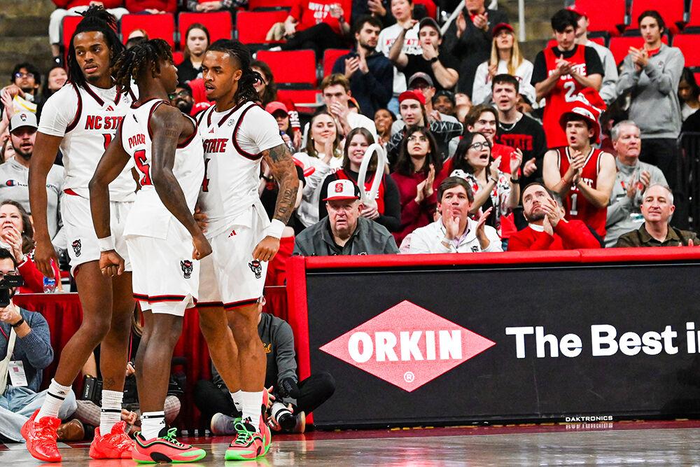 Freshman guard Trey Parker and senior guard Breon Pass celebrate after Pass scores during the game against California at the Lenovo Center on Saturday, Jan. 18, 2025. Parker scored four points and Pass scored seven. NC State lost the game 65-62.