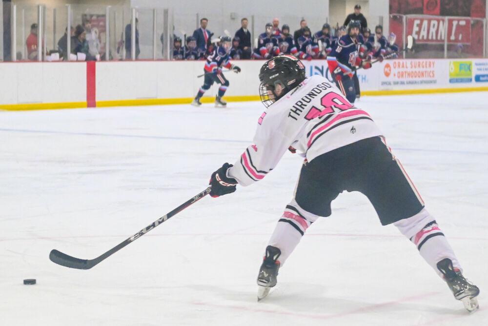 Sophomore defenseman Andrew Throndson passes the puck during the game against Liberty University at Invisalign Arena on Friday, Jan. 17, 2025. The Wolfpack lost to the Flames 5-4.
