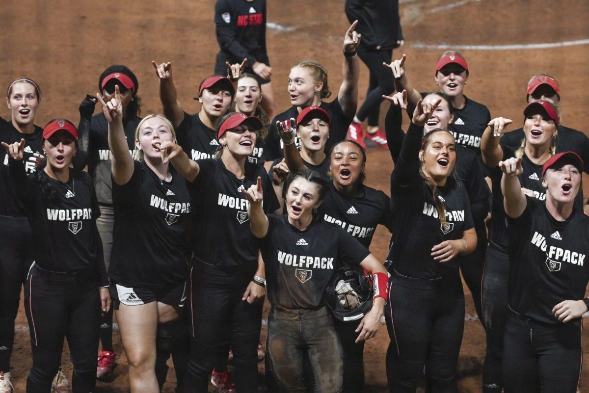 The team chants "Wolf" as the audience chants "Pack" during the game against Elon at Dail Softball Stadium on Wednesday, Oct. 23, 2024. The Wolfpack won the game 14-7.