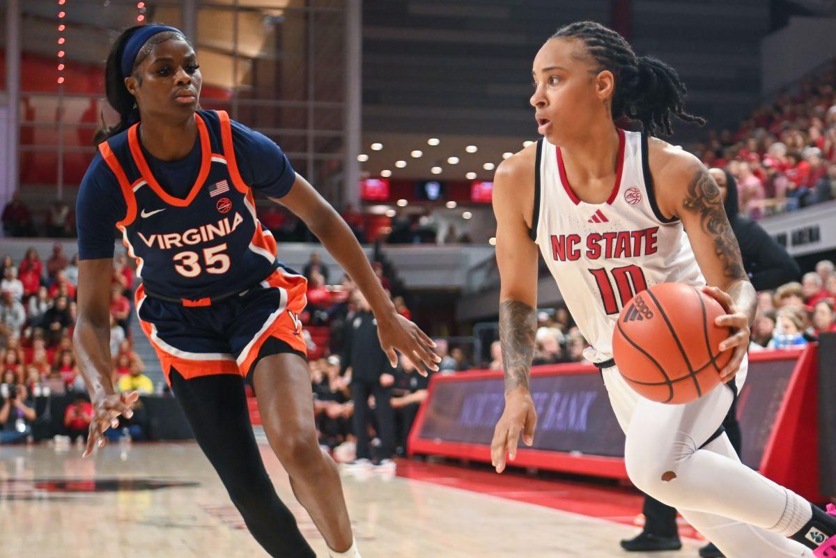 Senior guard Aziaha James drives the ball during the game against University of Virginia in Reynolds Coliseum on Sunday, Jan. 19, 2025. James led in scoring with 20 points and made four rebounds. NC State won the game against UVA 73-68.