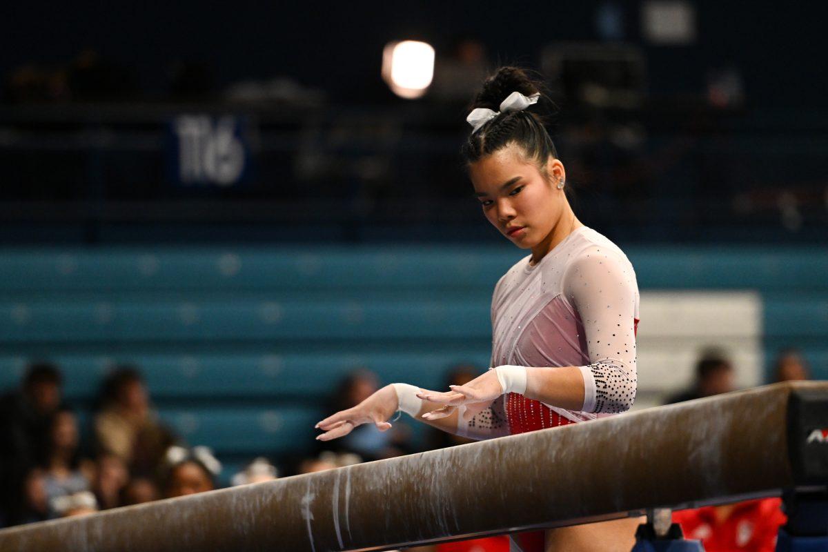 Sophomore Maddie Hall gets ready to mount the beam during the meet against UNC-Chapel Hill in Carmichael Arena on Friday, Jan. 24, 2025. Hall earned a score of 9.725 on the balance beam. The Wolfpack beat the Tar Heels 196.350-195.925.