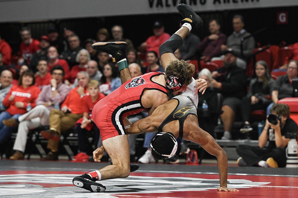 Redshirt sophomore Troy Hohman tackles his opponent during the duel against Appalachian State in Reynolds Coliseum on Friday, Nov. 15, 2024. Hohman lost the 133 bout 7-5. NC State defeated App State 34-12.