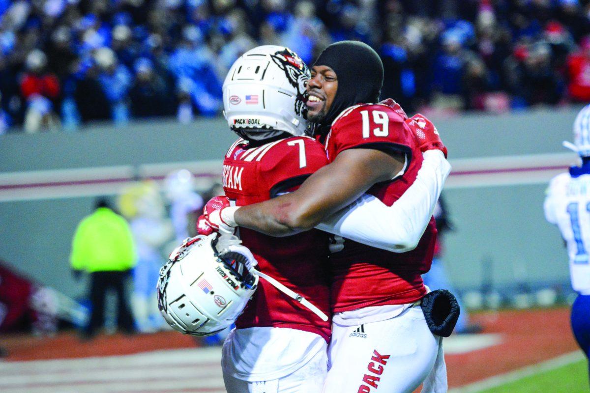 Graduate wide receiver C.J. Riley hugs sophomore running back Zonovan Knight in the game against UNC-Chapel Hill on Friday, Nov. 26, 2021, at Carter-Finley Stadium. The Wolfpack beat the Tar Heels 34-30.