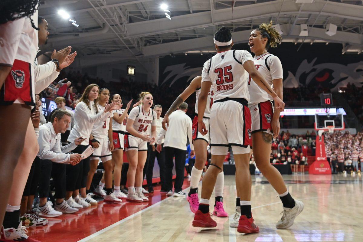 Sophomore guard Zoe Brooks chestbumps graduate guard Madison Hayes after Hayes shot a three-pointer during NC State's game against the Pitt Panthers in Reynolds Coliseum on Thursday, Jan. 16, 2024. Hayes recorded 13 points and three assists on 39 total minutes played. The Wolfpack beat the Panthers 83-67.