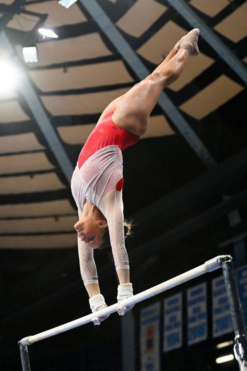 Freshman Caroline Volk rotates on the uneven bars during the meet against UNC-Chapel Hill in Carmichael Arena on Friday, Jan. 24, 2025. Volk earned a 9.750 on the uneven bars. The Wolfpack beat the Tar Heels 196.350-195.925.