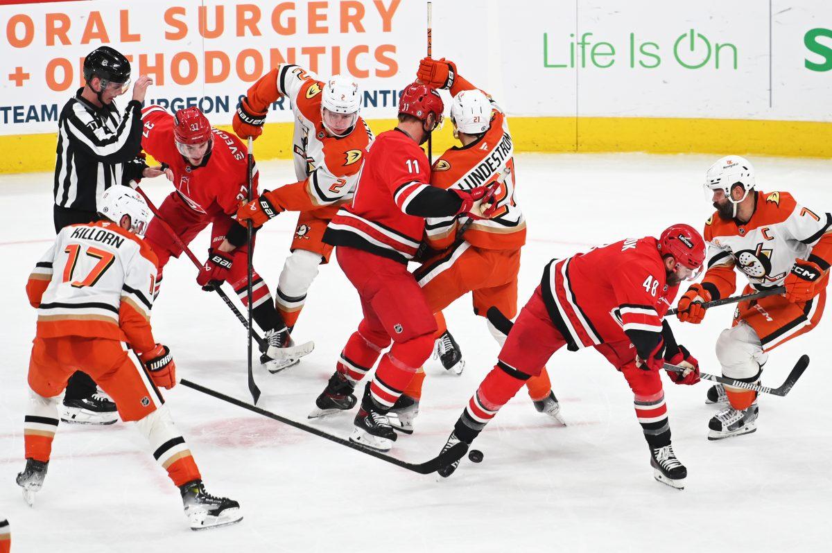 Right wing Andrei Svetchnikov, center Jordan Staal and defenseman Jordan Martinook battle opponents for the puck during the game versus the Anaheim Ducks at Lenovo Center on Sunday, Dec 12, 2024. Svetchnikov scored one goal for the Hurricanes. The Ducks beat the Hurricanes 3-2 in overtime.