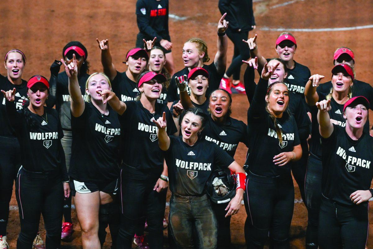 The team chants "Wolf" as the audience chants "Pack" during the game against Elon at Dail Softball Stadium on Wednesday, Oct. 23, 2024. The Wolfpack won the game 14-7.