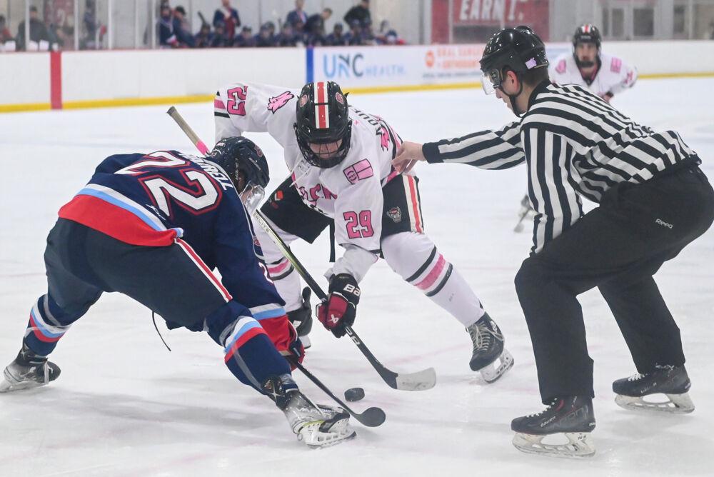 Sophomore forward Holden Koufman battles for the puck during the game against Liberty University at Invisalign Arena on Friday, Jan. 17, 2025. The Wolfpack lost to the Flames 5-4.