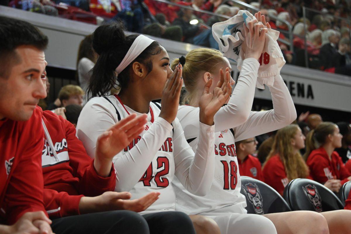 Sophomore center Mallory Collier and freshman forward Tilda Trygger cheer on their team during the match against Virginia Tech in Reynolds Coliseum on Sunday, Jan. 26, 2025. NC State had 42 rebounds total. The Wolfpack beat the Hokies 85-57.