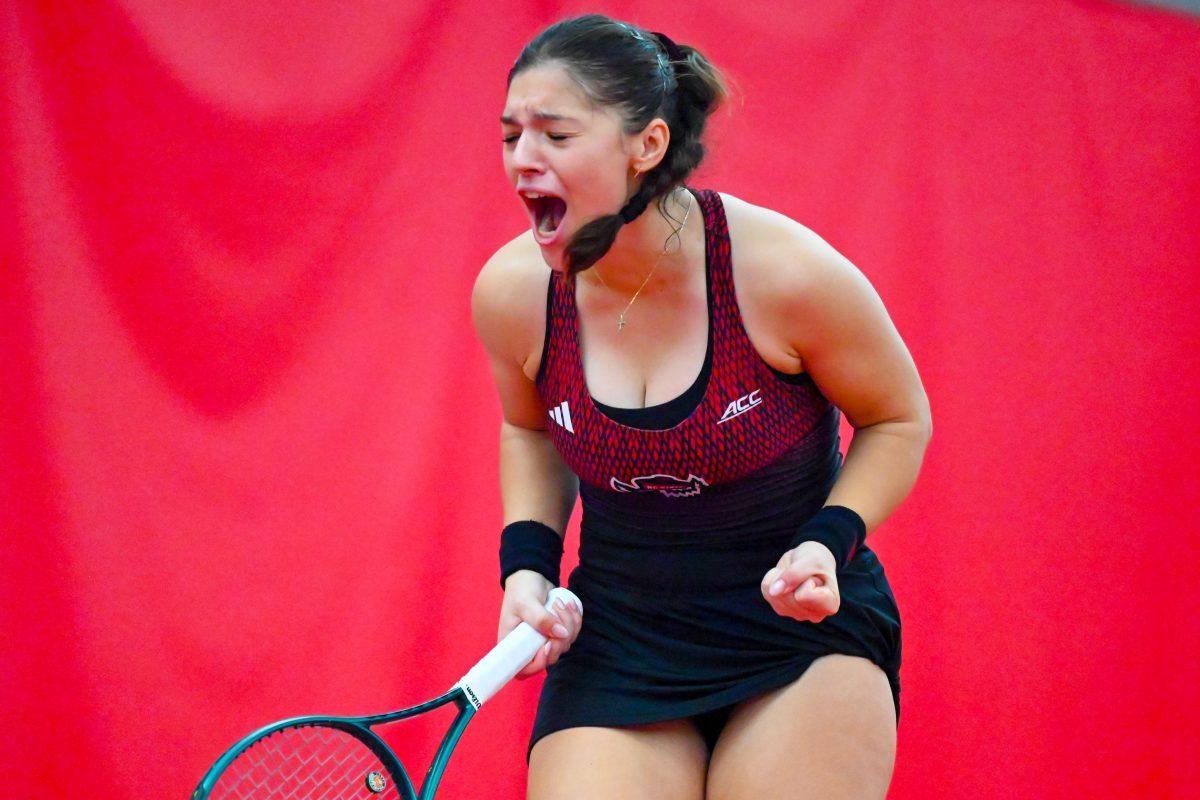 Freshman Michaela Laki yells after scoring in her singles game against Pepperdine player Savannah Broadus on Sunday, Jan. 19, 2025 at the J.W. Isenhour Tennis Center. Laki won her singles match 2-0, with scores of 6-4 and 6-4 for the individual sets. NC State won the match 5-2.