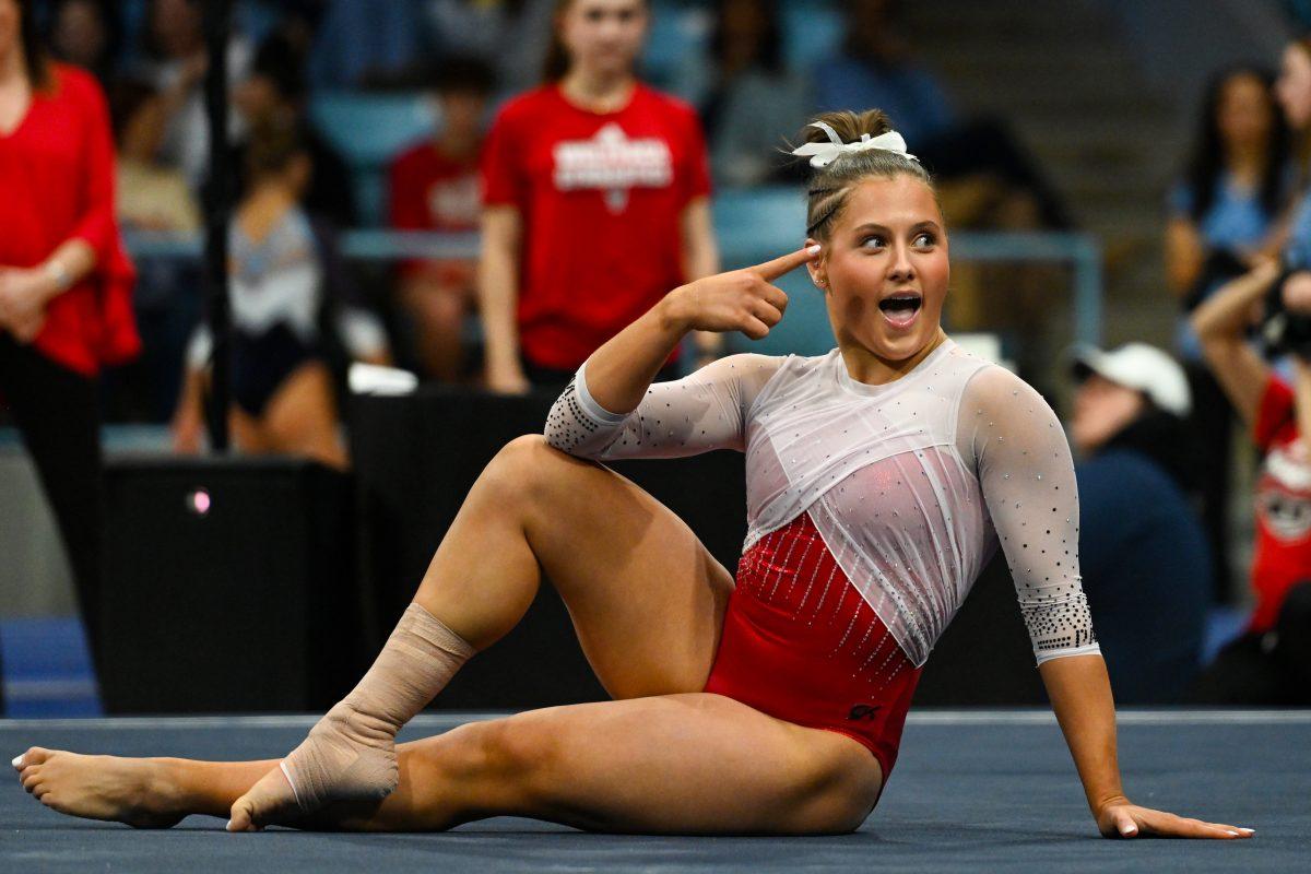 Sophomore Elle Hadrick points during her floor routine during the meet against UNC-Chapel Hill in Carmichael Arena on Friday, Jan. 24, 2025. Hadrick earned a 9.675 on her floor routine. The Wolfpack beat the Tar Heels 196.350-195.925.
