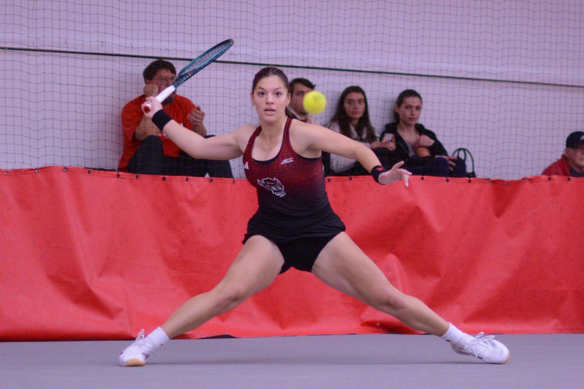 Freshman Michaela Laki lunges to reach the ball during the match against Pepperdine at J.W. Isehour Tennis Center on Saturday, Jan. 19, 2025. Laki won her doubles match 2-0. NC State defeated Pepperdine 5-2.