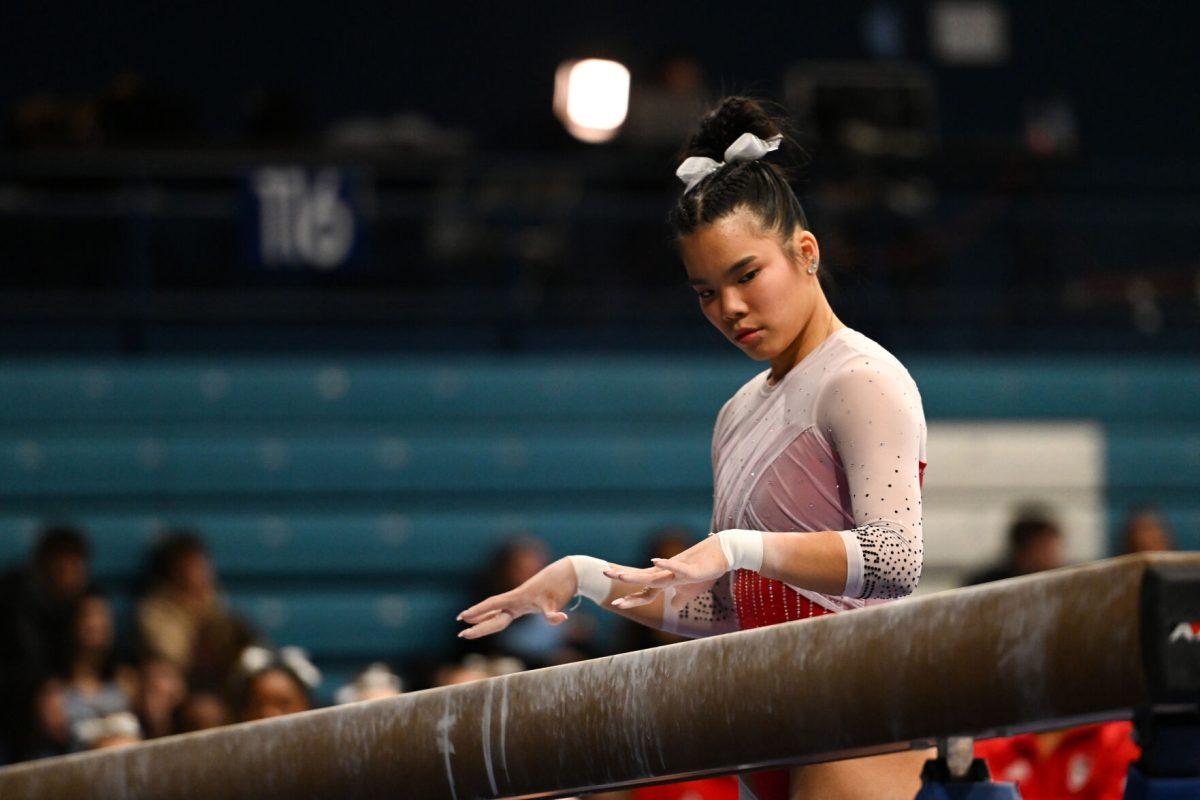 Sophomore Maddie Hall gets ready to mount the beam during the meet against UNC-Chapel Hill in Carmichael Arena on Friday, Jan. 24, 2025. Hall earned a score of 9.725 on the balance beam. The Wolfpack beat the Tar Heels 196.350-195.925.