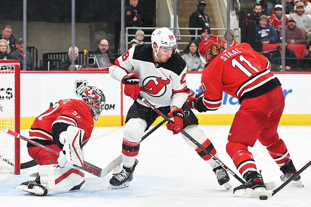Center Jordan Staal battles an opponent for the puck during the Hurricanes game against the New Jersey Devils at Lenovo Center on Tuesday, Oct. 15, 2024. The Hurricanes beat the Devils 4-2.