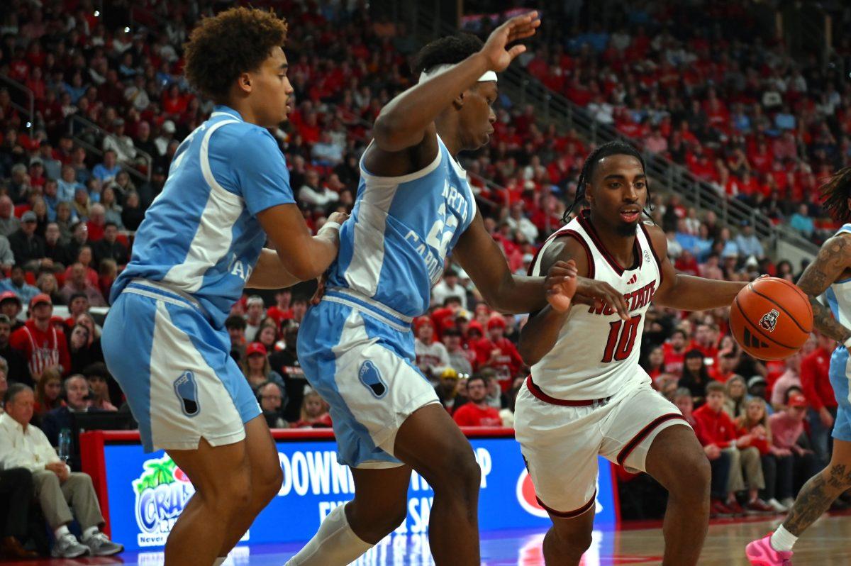 Senior guard Marcus Hill rushes pass UNC-Chapel Hill's defense at Lenovo Center on Saturday, Jan. 11, 2025, during the game against UNC Chapel Hill. Hill led the team in points by scoring 20 total points. UNC-Chapel Hill defeated NC State 63-61.