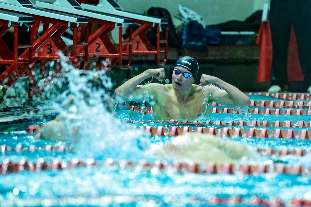 Graduate Owen Lloyd flexes at teammate Lance Norris after placing first and second in the 500m freestyle during the meet against UNC-Chapel Hill in Casey Aquatics Center&#160;on Friday, Jan. 17, 2025. NC State men defeated UNC men 165-134.