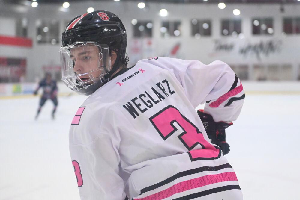 Freshman defenseman Jackson Weglarz eyes the puck during the game against Liberty University at Invisalign Arena on Friday, Jan. 17, 2025. The Wolfpack lost to the Flames 5-4.