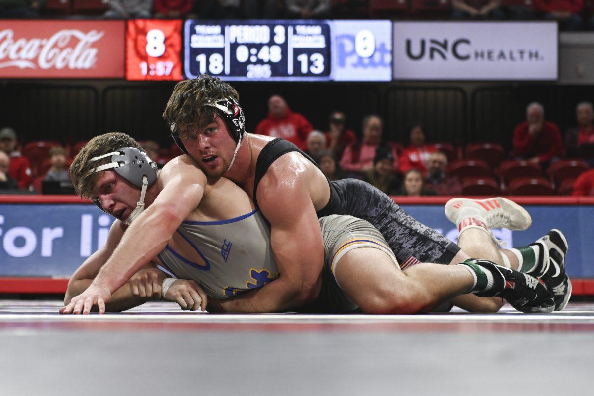 Redshirt junior Isaac Trumble keeps his opponent on the mat during the duel against Pitt in Reynolds Coliseum on Friday, Jan. 24, 2025. Trumble won the 285 bout 10-1. NC State defeated Pitt 22-13.