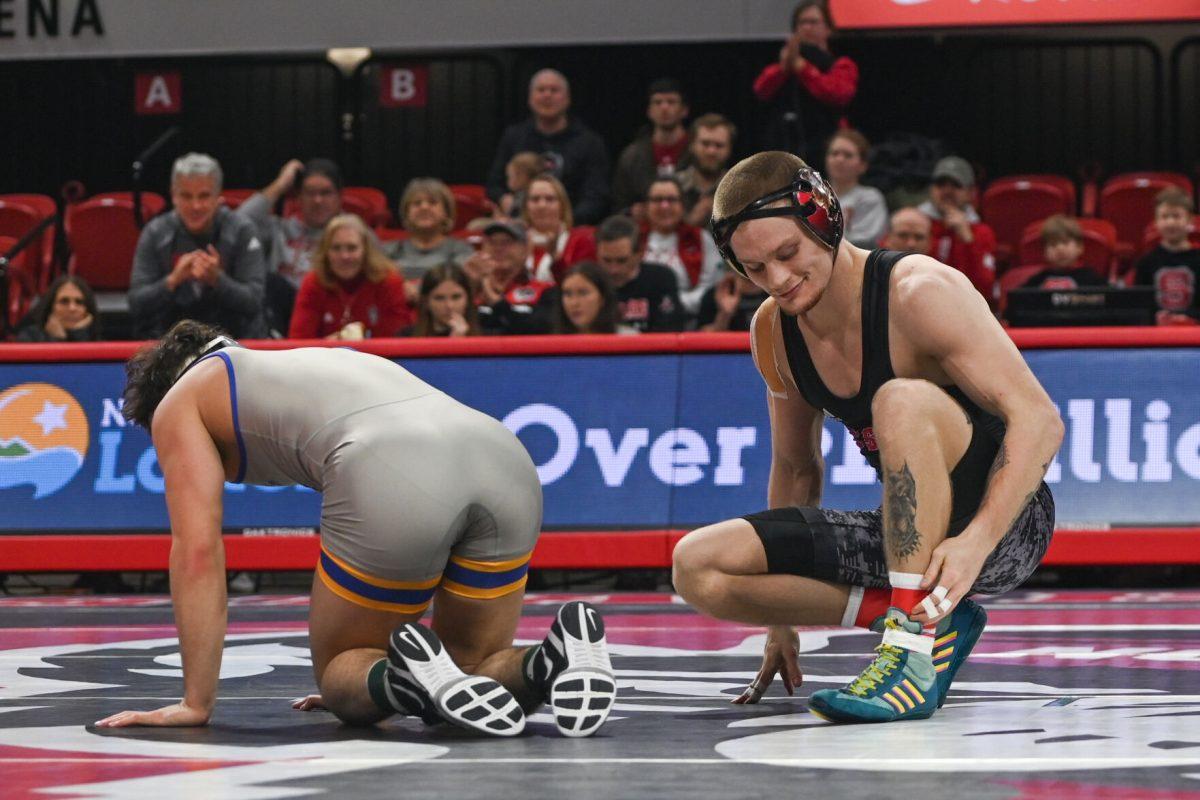Redshirt senior Kai Orine smirks after a victory during the match against Pitt in Reynolds Coliseum on Friday, Jan. 24, 2025. Orine won the 133 bout 17-0. NC State beat Pitt 22-13.