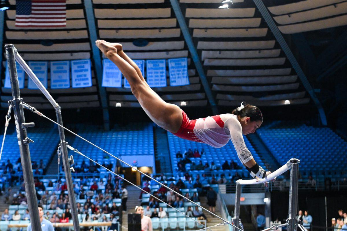 Junior Madeline Reid transitions between the uneven bars during the meet against UNC-Chapel Hill in Carmichael Arena on Friday, Jan. 24, 2025. Reid earned a 9.750 on the uneven bars. The Wolfpack beat the Tar Heels 196.350-195.925.
