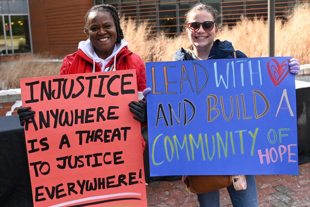 Delana Epps, associate director of the Women's Center, and Alicia Marrero, a graduate student studying social work, pose with their signs during March Like Martin from Stafford Commons to Harris Field on Friday, Jan. 24, 2025. During this annual event, participants march from Stafford Commons to Harris Field.