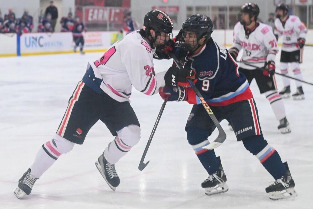 Freshman defenseman Jake Lipani collides with another player during the game against Liberty University at Invisalign Arena on Friday, Jan. 17, 2025. The Wolfpack lost to the Flames 5-4.