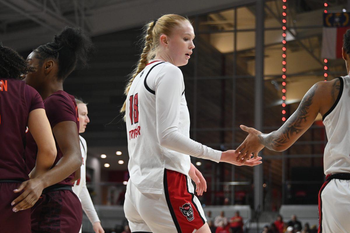 Freshman forward Tilda Trygger high fives a teammate during the match against Virginia Tech in Reynolds Coliseum on Sunday, Jan. 26, 2025. Trygger had one rebound and scored four points. The Wolfpack beat the Hokies 85-57.