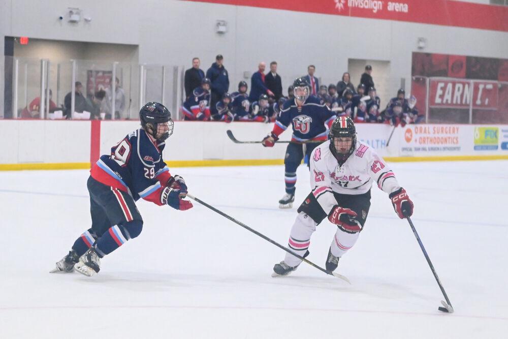 Sophomore forward Nick Shook redirects the puck during the game against Liberty University at Invisalign Arena on Friday, Jan. 17, 2025. The Wolfpack lost to the Flames 5-4.
