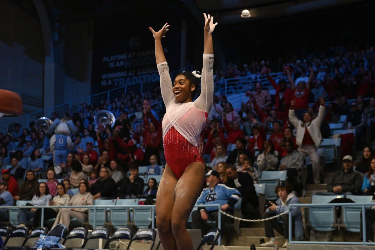 Sophomore Lauren Wright poses after sticking her landing from the vault during the meet against UNC-Chapel Hill in Carmichael Arena on Friday, Jan. 24, 2025. Wright scored a 9.825 average on the vault. NC State beat UNC 196.350-195.925.