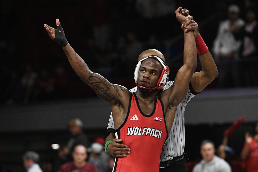 Redshirt freshman Vince Robinson celebrates his win during the duel against Appalachian State in Reynolds Coliseum on Friday, Nov. 15, 2024. Robinson won the 125 bout by technical fall. The Wolfpack defeated the Mountaineers 34-12.