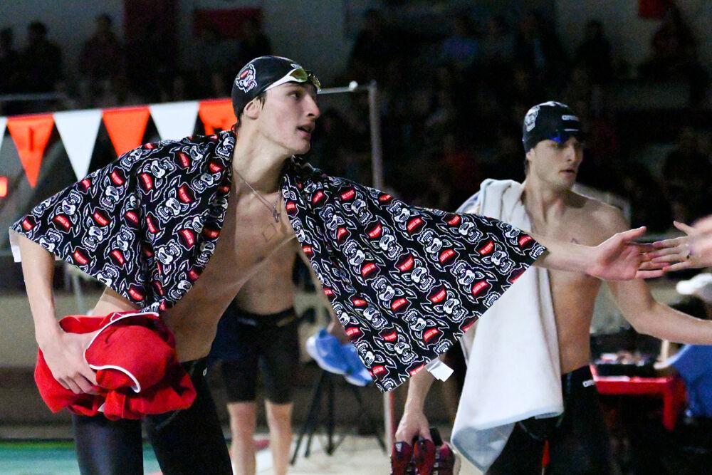 Sophomore Wells Walker high-fives a member of the crowd during the swim and dive meet against UNC-Chapel Hill in the Casey Aquatic Center on Friday, Jan. 17, 2025. Walker placed seventh in the men's 50 free. NC State beat UNC 165-134.