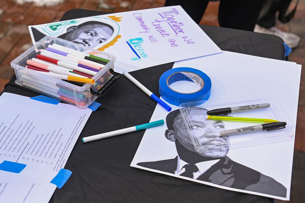 Craft supplies and pictures of Martin Luther King lay on a table during March Like Martin from Stafford Commons to Harris Field on Friday, Jan. 24, 2025. The Gregg Museum of Art and Design provided pages with pictures of Martin Luther King and markers for marchers to craft signs.