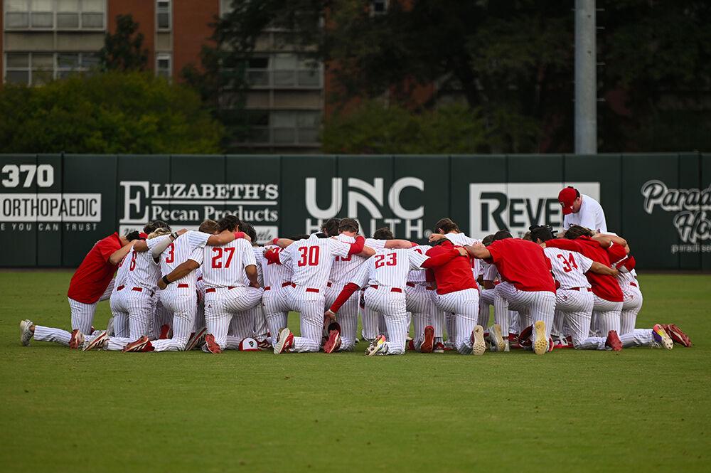 NC State's baseball team huddles up before their game against Elon at Doak Field at Dail Park on Wednesday, Oct. 9, 2024. NC State defeated Elon 20-4.
