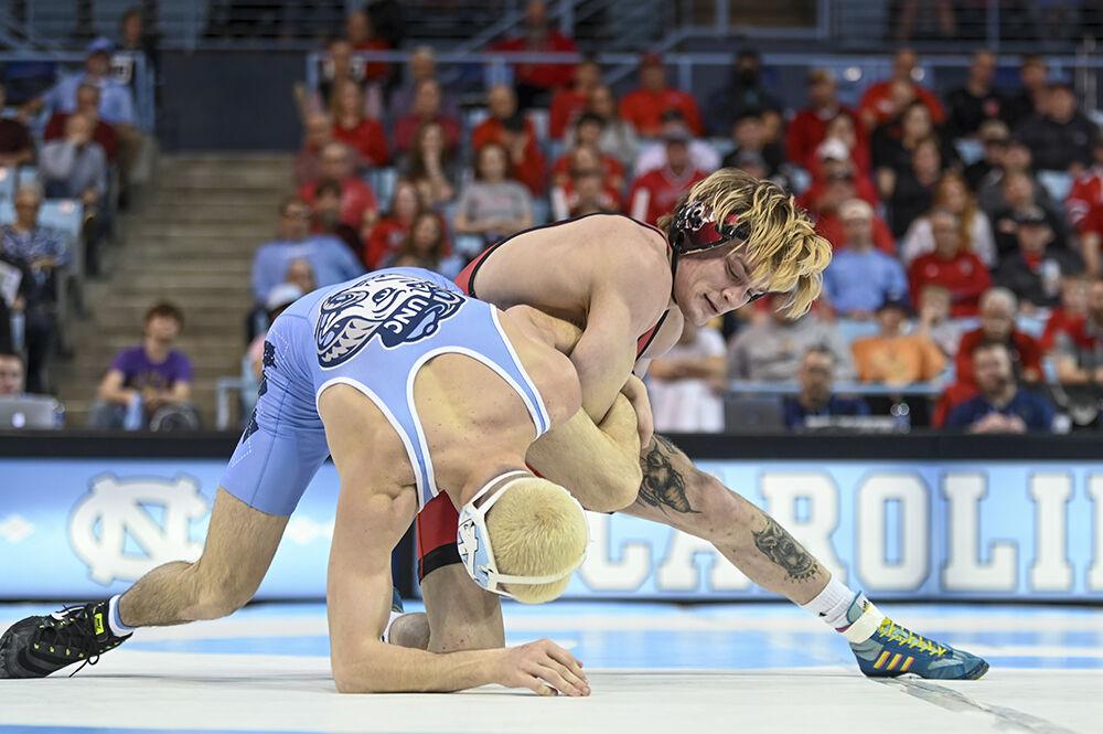 Redshirt sophomore Kai Orine restrains his opponent's arm during the wrestling duel against UNC-Chapel Hill in Carmichael Arena on Friday, Feb. 17, 2023. NC State beat UNC 28-6.