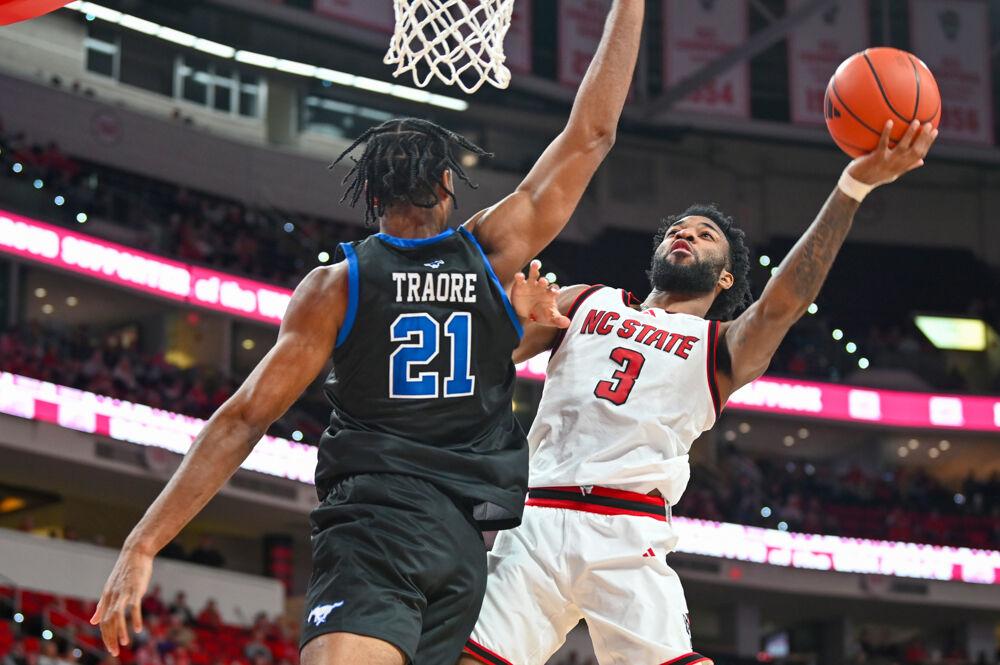 Senior forward Dontrez Styles attempts a contested layup during the game against SMU in the Lenovo Center on Saturday, Jan. 25, 2025. Styles finished with 12 points. The Wolfpack lost to the Mustangs 63-57.&#160;