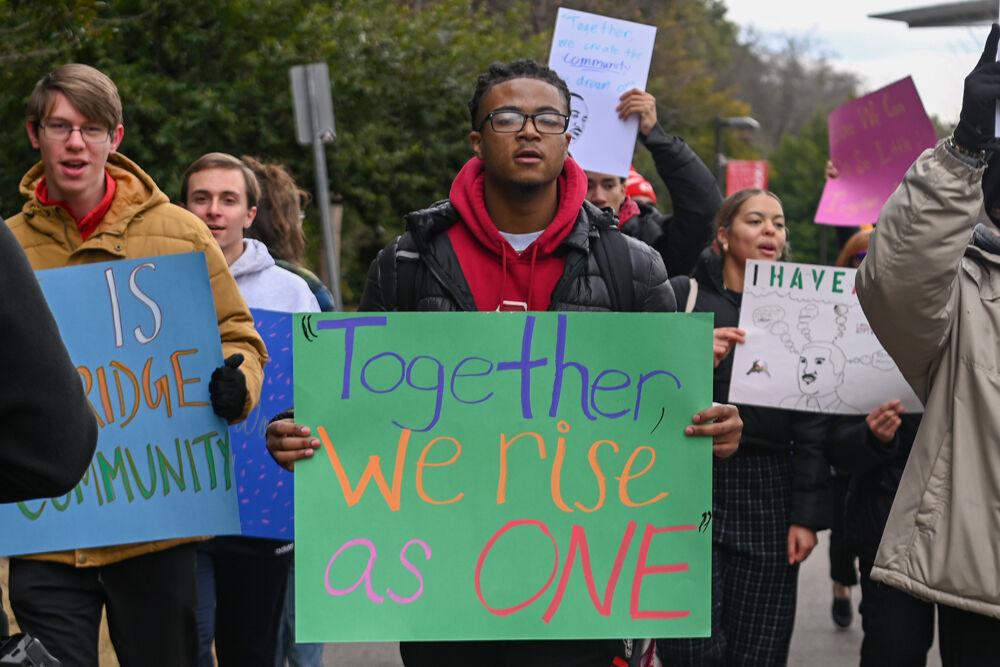 Juail Brim, a second-year studying agricultural business, walks with a sign among other marchers during March Like Martin from Stafford Commons to Harris Field on Friday, Jan. 24, 2025. This year marked the fourth annual March Like Martin event.