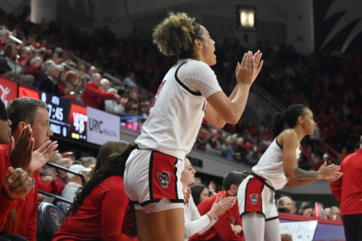 Graduate guard Madison Hayes celebrates her team from the bench during the match against Virginia Tech in Reynolds Coliseum on Sunday, Jan. 26, 2025. Hayes had six rebounds and scored 12 points. The Wolfpack beat the Hokies 85-57.