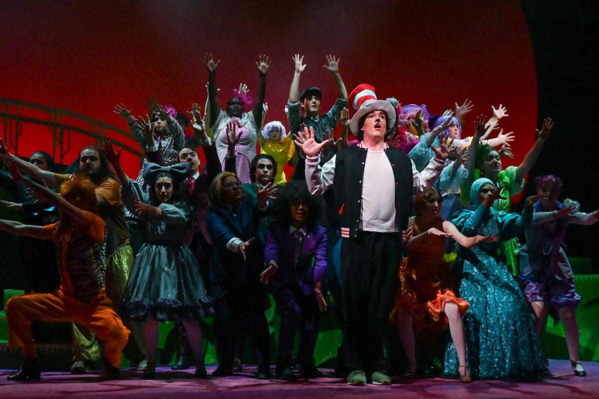 The ensemble stands around Owen Durso, a first-year studying nuclear engineering, who performs as Cat in the Hat during a performance of "Seussical" in Stewart Theater on Tuesday, Feb. 18, 2025. "Seussical" is runs from Feb. 20-23. The performance is based on various works by Dr. Seuss and is directed by Mia Self, assistant director of acting and directing at University Theater.