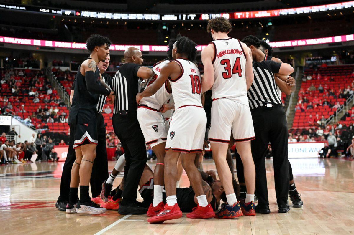 Players on both teams help their teammates up after a struggle for possession during the game against University of Louisville at the Lenovo Center on Wednesday, Feb. 12, 2025. NC State lost 91-66.