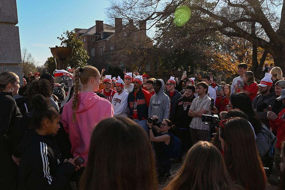 The NC State's women's basketball team celebrates their upset win against Notre Dame with fans at the Memorial Belltower on Sunday, Feb. 23, 2025.