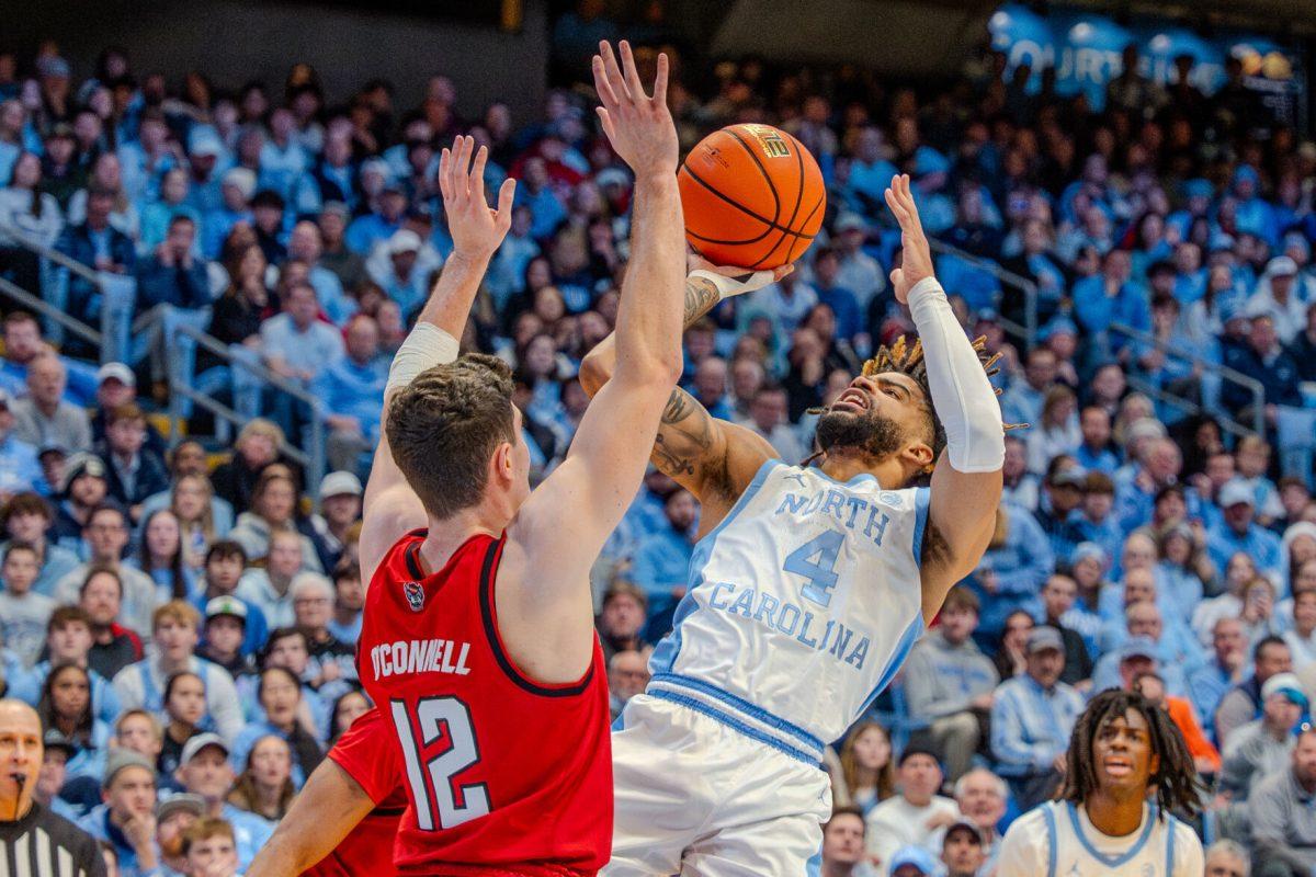 Graduate guard Michael O'Connell attempts to block a shot during the game against the University of North Carolina Chapel Hill in the Dean E. Smith Center on Wednesday, Feb. 19, 2025. O'Connell scored eight points and made two rebounds. NC State lost the game 97-73.