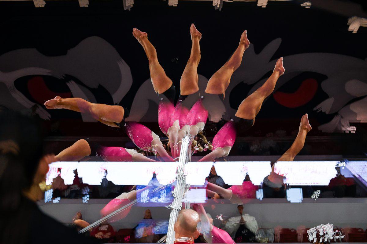 Senior Peyton Childs rotates on the uneven bars during NC State's home gymnastics meet against the Pitt Panthers in Reynolds Coliseum on Saturday, Feb. 8, 2025. Childs recorded a 9.225 on the uneven bars. The Wolfpack beat the Panthers 196.475-193.600.