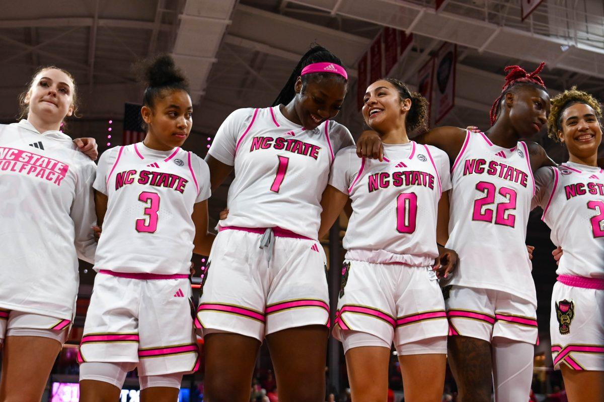The team stands together after winning the Play4Kay game against Duke at Reynolds Coliseum on Monday, Feb. 3, 2025. The Wolfpack beat the Blue Devils 89-83.