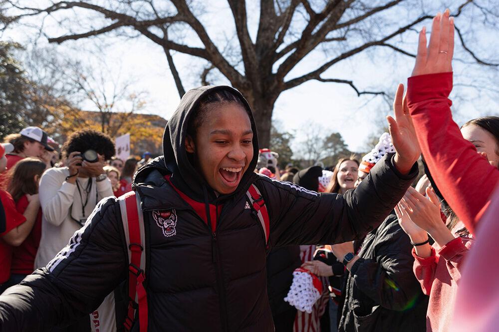 Sophomore guard Zoe Brooks cheers as she high-fives fans at the Memorial Belltower on Sunday, Feb. 23, 2025. Alongside a victory against top-ranked Notre Dame, Brooks celebrated a career high 33 points.