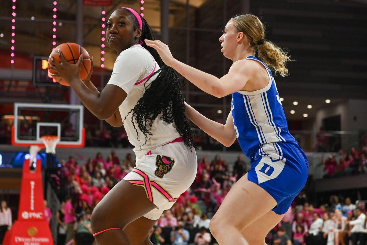 Freshman cener Lorena Awou frowns while trying to pass the ball during the game against Duke in Reynolds Coliseum on Feb. 3, 2025. Awou scored eight points and made four rebounds. NC State won the game 89-83.