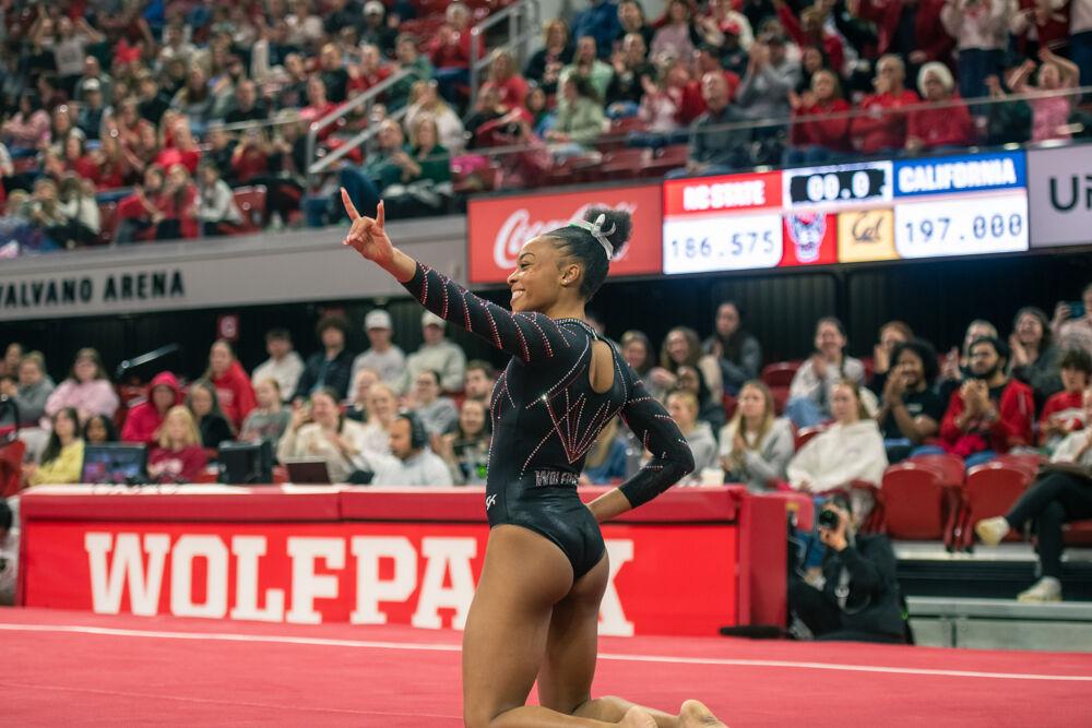 Sophomore Ashley Knight holds up a wolfie during the meet against California in Reynolds Coliseum on Sunday, Feb. 2, 2025. Knight scored 9.925 points during the floor routine. The Wolfpack lost to the Bears 197.175-196.550